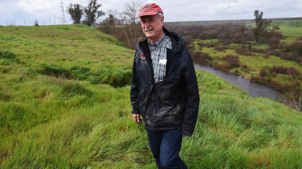 John Marshall, who owns the Fresno County Horse Park, walks along the edge of the neighboring 17.5 acre plot of land that may be rezoned for houses near the San Joaquin River and Highway 99. Fresno’s General Plan currently indicates the land is to become a park.