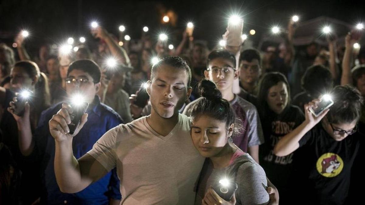 Matthew Mata and Erika Gonzalez participate in a memorial service for the victims of Sunday's church shooting in Sutherland Springs, Texas, on Monday, Nov. 6, 2017. The suspected gunman had a history of domestic violence and sent threatening text messages to his mother-in-law, a member of the church, before the attack in which he fired at least 450 rounds at helpless worshippers, authorities said Monday. Despite the shooter’s crimes, he was still allowed to buy a gun.