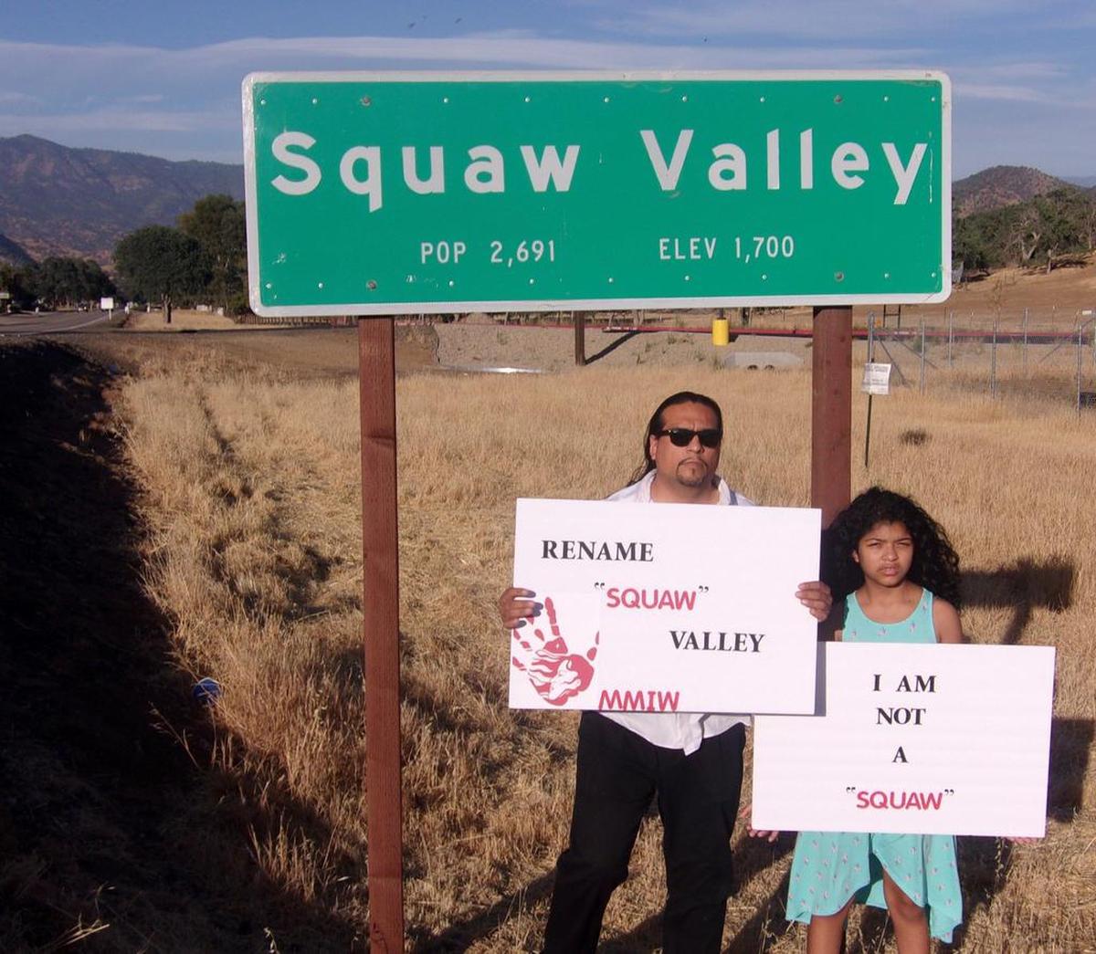Roman Rain Tree with his daughter, Lola, in front of the town sign for Squaw Valley in Fresno County, California.