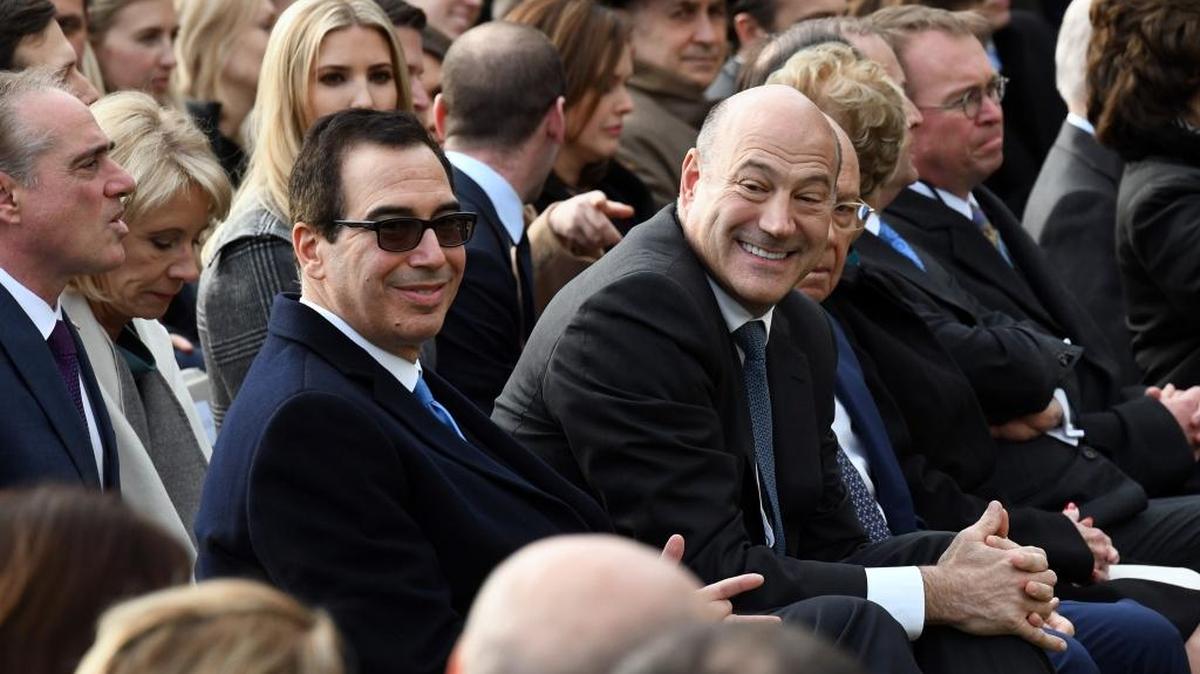 U.S. Treasury Secretary Steven Mnuchin, left, and National Economic Council Director Gary Cohn wait for U.S. President Donald Trump to speak about newly passed tax reform legislation on Dec. 20 during an event on the South Lawn of the White House in Washington, D.C.