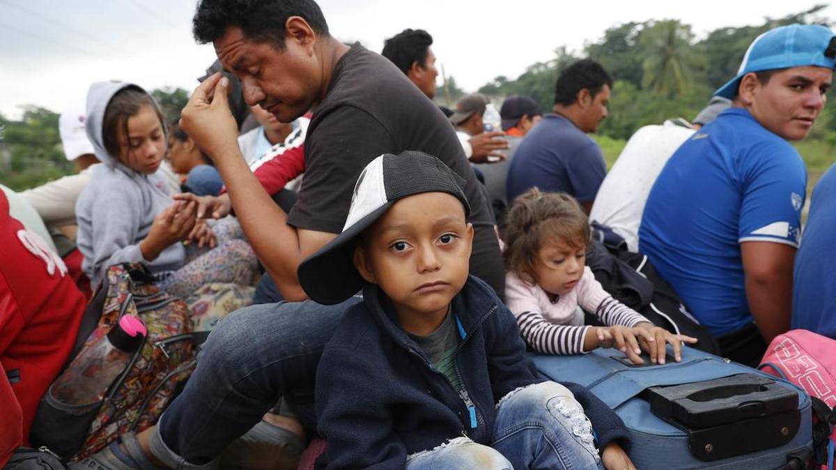 Central American migrants, part of the caravan hoping to reach the U.S. border, get a ride on the bed of a semi flat bed trailer, in Donaji, Oaxaca state, Mexico, Friday, Nov. 2, 2018. The migrants had already made a grueling 40-mile (65-kilometer) trek from Juchitan, Oaxaca, after they failed to get the bus transportation they had hoped for. But hitching rides allowed them to get to Donaji early, and some headed on to a town even further north, Sayula.