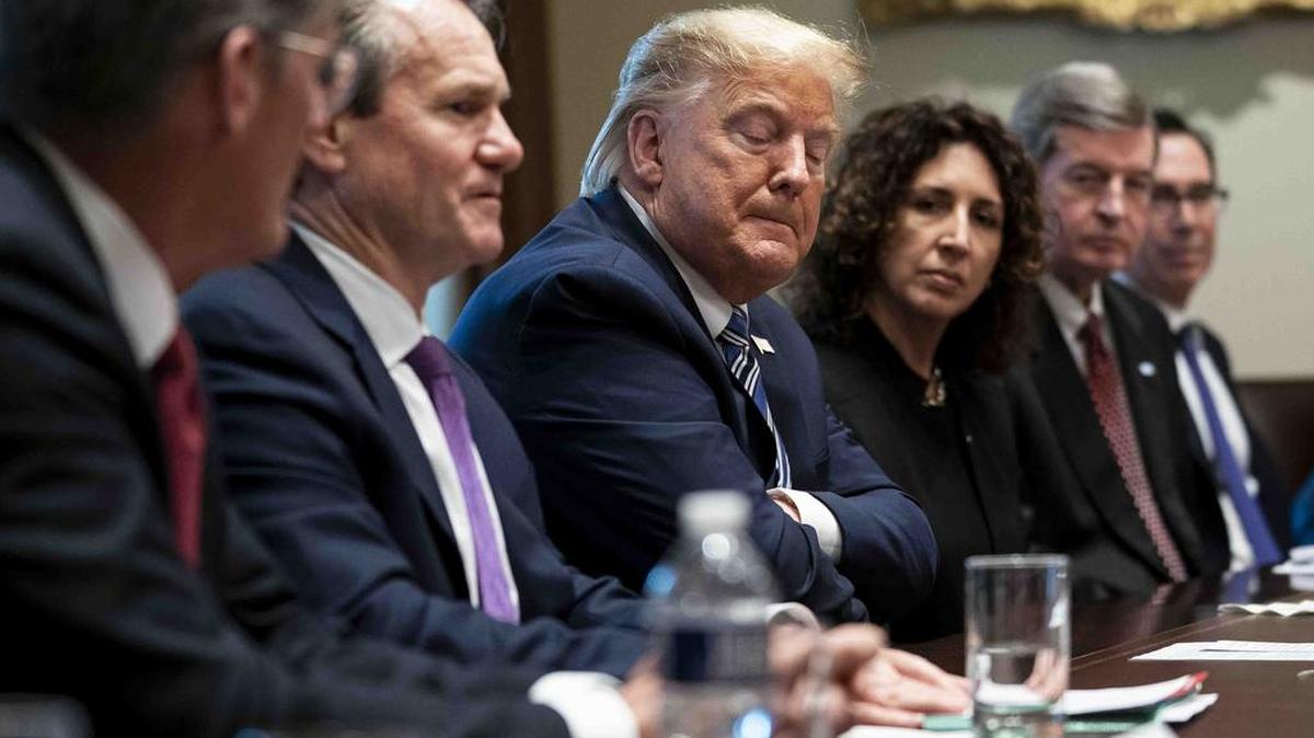 President Donald Trump listens as he meets with bankers about the response to the coronavirus, at the White House in Washington, Wednesday, March, 11, 2020.