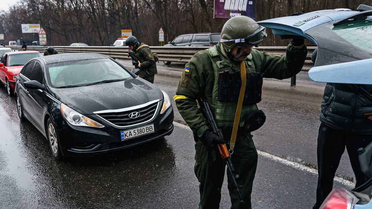 Soldiers check vehicles at a checkpoint on a main road entering Kyiv, Ukraine, on March 2, the seventh day of the Russian invasion.