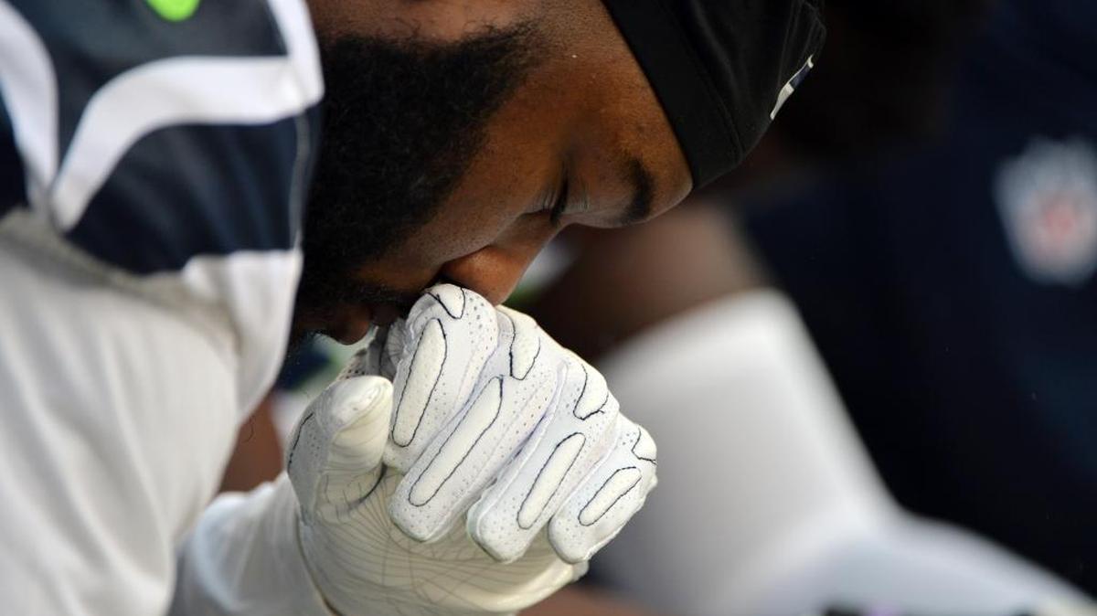 A Seattle Seahawks player kneels as the national anthem plays before an NFL football game against the San Francisco 49ers Sunday in Santa Clara.