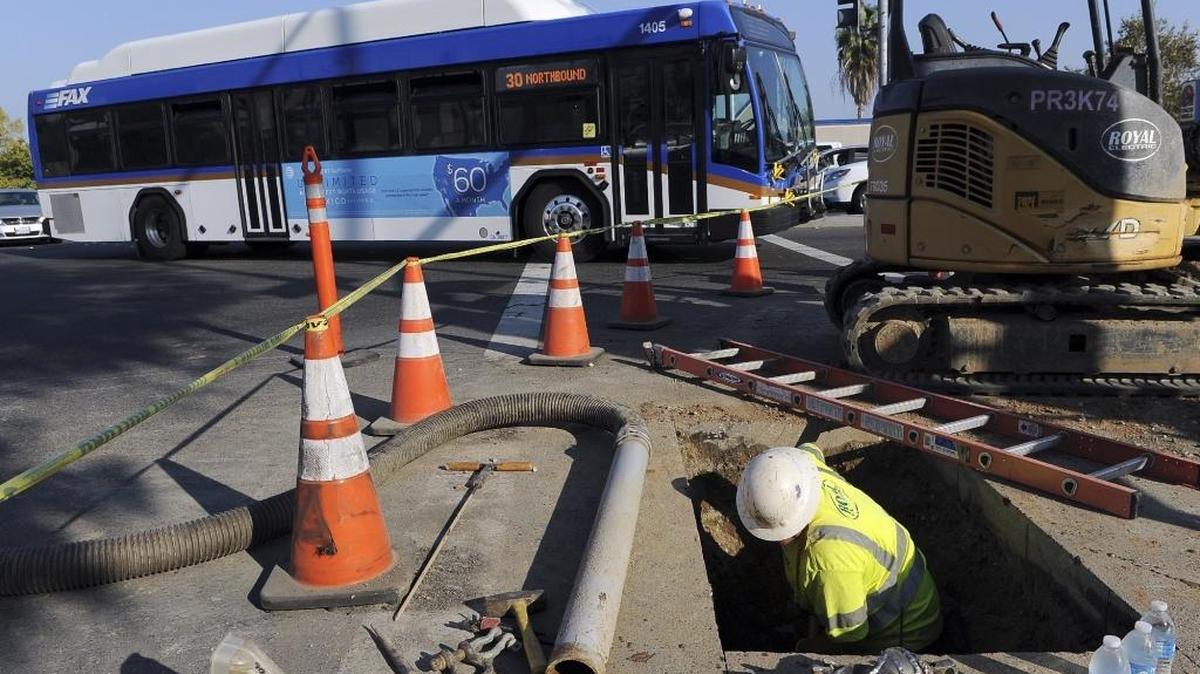 A FAX bus passes construction for the Bus Rapid Transit system at Herndon and Blackstone avenues Nov. 15, 2016.