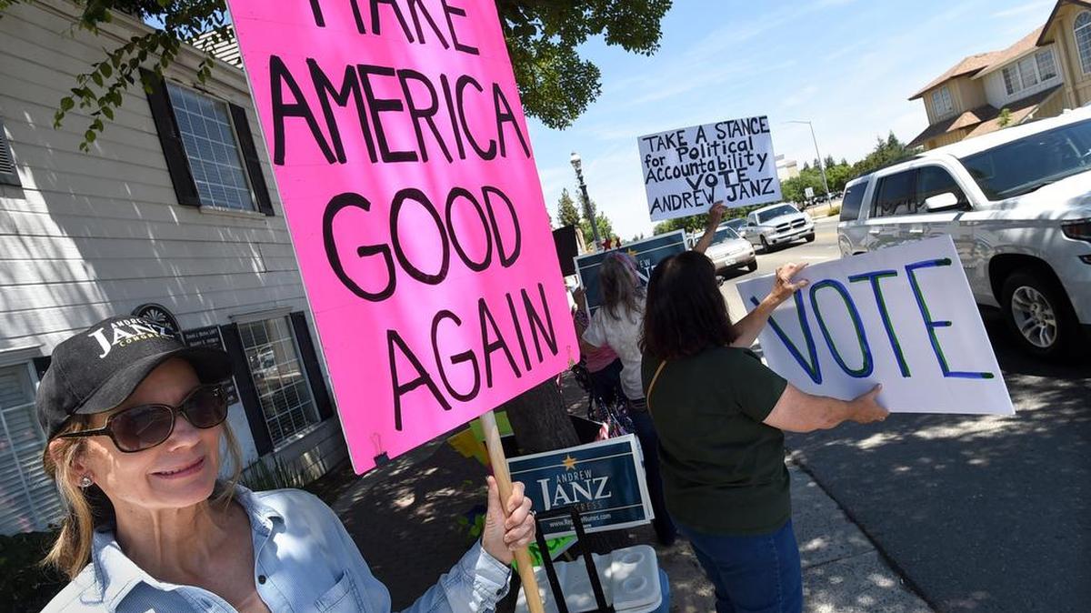 Melinda Pitarre stands with protestors outside Devin Nunes’ office in Old Town Clovis, Tuesday afternoon, June 5, 2018.