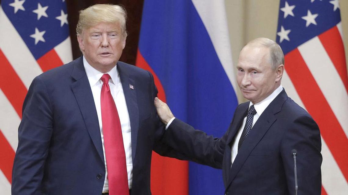 Then President Donald Trump, left, and Russian President Vladimir Putin give a joint news conference following their meeting at the Presidential Palace in Helsinki, Finland, on July 16, 2018.