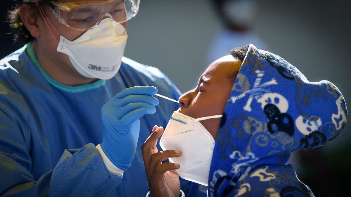 10-year-old Qdaziae Williams is tested for COVID-19 by Dr. Kenny Banh, UCSF assistant dean of undergraduate medical education, during a mass testing event for coronavirus in southwest Fresno in June 2020. As more government agencies and other organizations require their workers to provide proof of a COVID-19 vaccine or else have a weekly coronavirus test, demand for testing has increased in Fresno County by mid-August 2021.