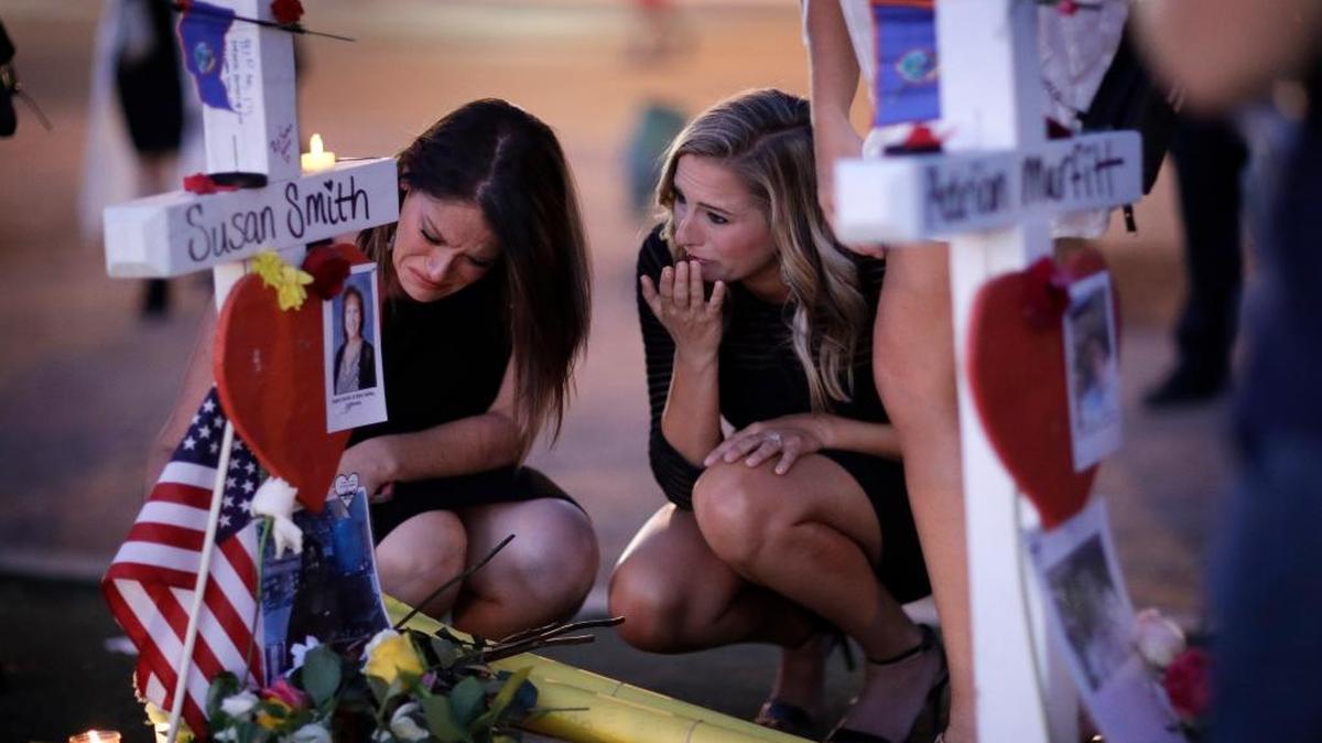Loved ones gather around a memorial for the victims of the Las Vegas massacre. Stephen Paddock died alone with only his guns for comfort, a “deplorable, lonely man” writes Teresa Romero. But he could not stop the human kindness, caring and heroism among others.
