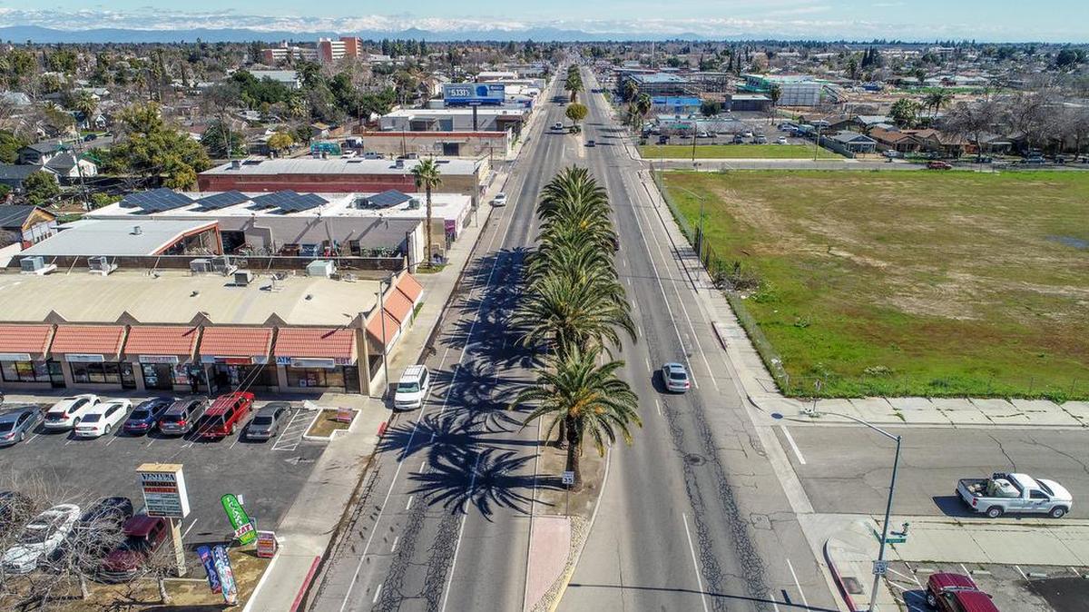 Palm trees line the median at Ventura Avenue looking east from Seventh Avenue toward Kings Canyon Road and southeast Fresno on Thursday, March 2, 2023. The roads are to be renamed to honor Cesar Chavez.