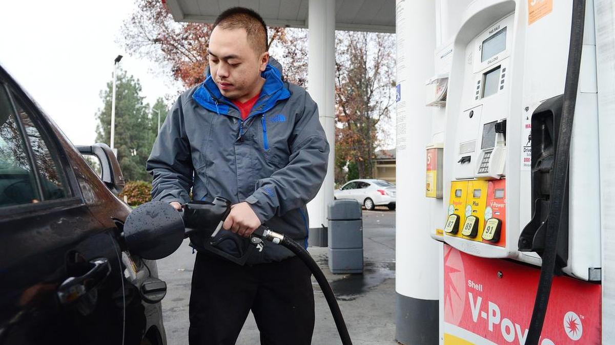 Kou Vue of Fresno pumps gas at a Shell gas station on McKinley and Peach avenues in Fresno on Dec. 23, 2016. California voters in November will decide if the latest gas tax should be repealed.