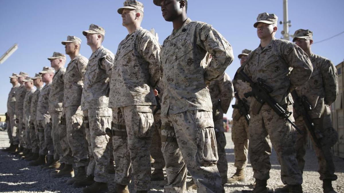 In this 2018 photo, U.S. Marines watch during the change of command ceremony at Task Force Southwest military field in Shorab military camp of Helmand province, Afghanistan.