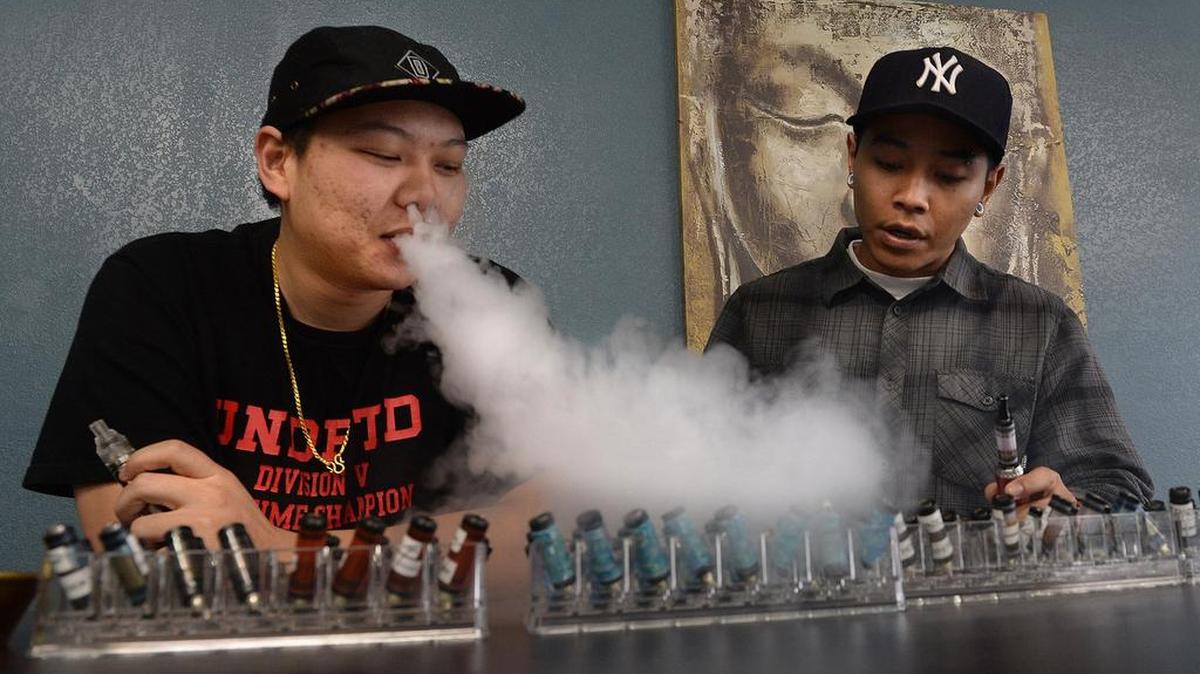 Anthony Lovan, left, and Johnny Phean sampling vape “flavor” at Royal Vapes on Tulare Street in this file photo from 2013.