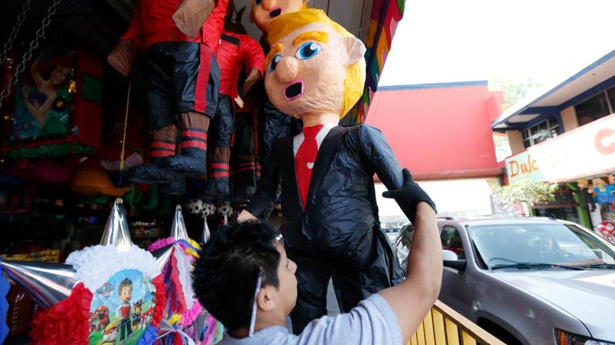 A piñata vendor adjusts a pinata in the image of Republican presidential candidate Donald Trump March 2, 2016, in Tijuana, Mexico. Former Mexican President Vicente Fox stands by his comparison of Donald Trump to Adolf Hitler, saying the Republican presidential front-runner believes in the white supremacy.