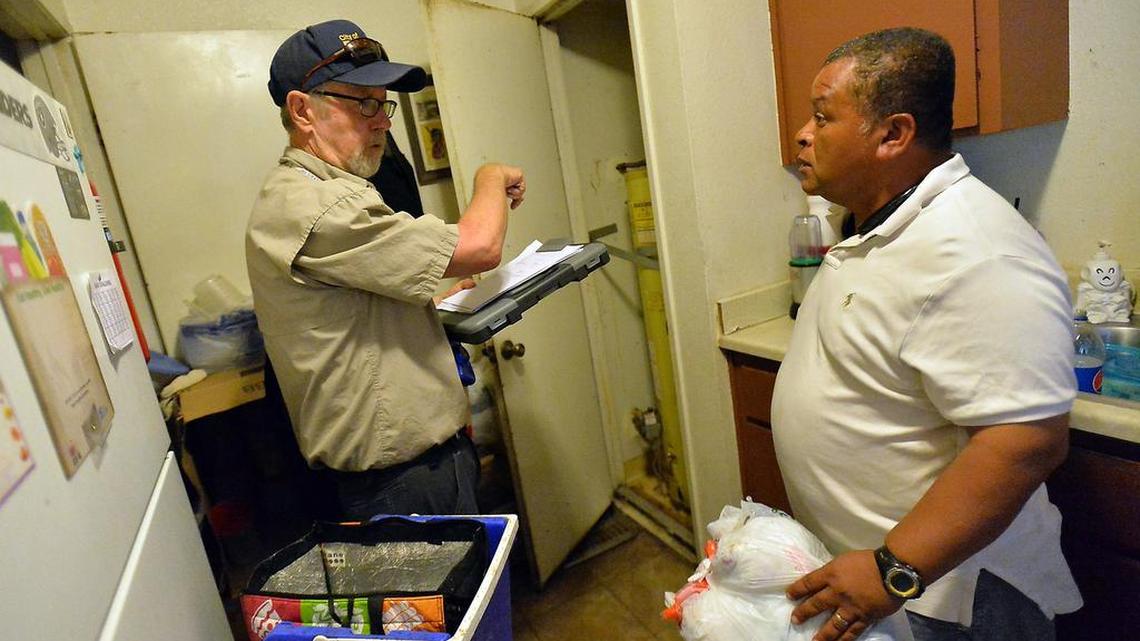 Senior code inspector Stephen Cox, left, inspected Luis Decubas’ apartment at 2061 S. Hayston Ave. in southeast Fresno in 2016. The apartment complex was featured in The Fresno Bee’s Living in Misery project, which found the Decubas’ family living with a roach and mice infestation, mold, and maintenance problems.