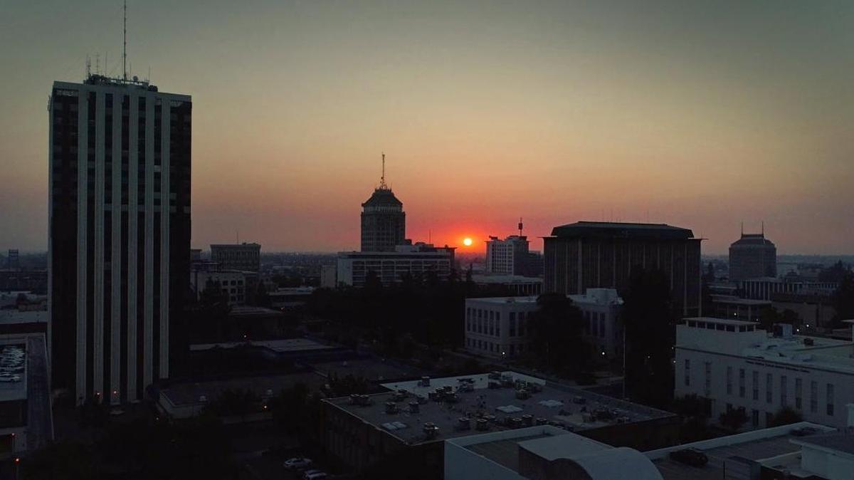 Residents in the greater Fresno area can expect degraded air quality due to wildfires burning in the region, the San Joaquin Valley Air Pollution said Wednesday, June 24, 2020. The sunset behind the Fresno skyline in this October 2017 file photo was impacted by smoke from several wildfires in Northern California.