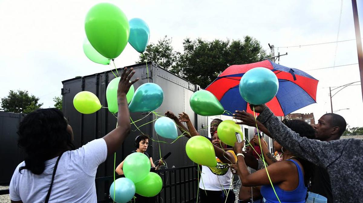 A group of friends release balloons Tuesday, July 30, 2019 at the scene where two women were killed in a drive-by shooting on Friday, July 26.