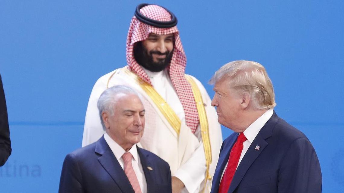 Saudi Arabia’s Crown Prince Mohammed bin Salman, center top, watches President Donald Trump, right, walk past as Brazil's President Michel Temer, left, stands by while leaders gather for the group photo at the start of the G20 summit in Buenos Aires, Argentina, Friday, Nov. 30, 2018.
