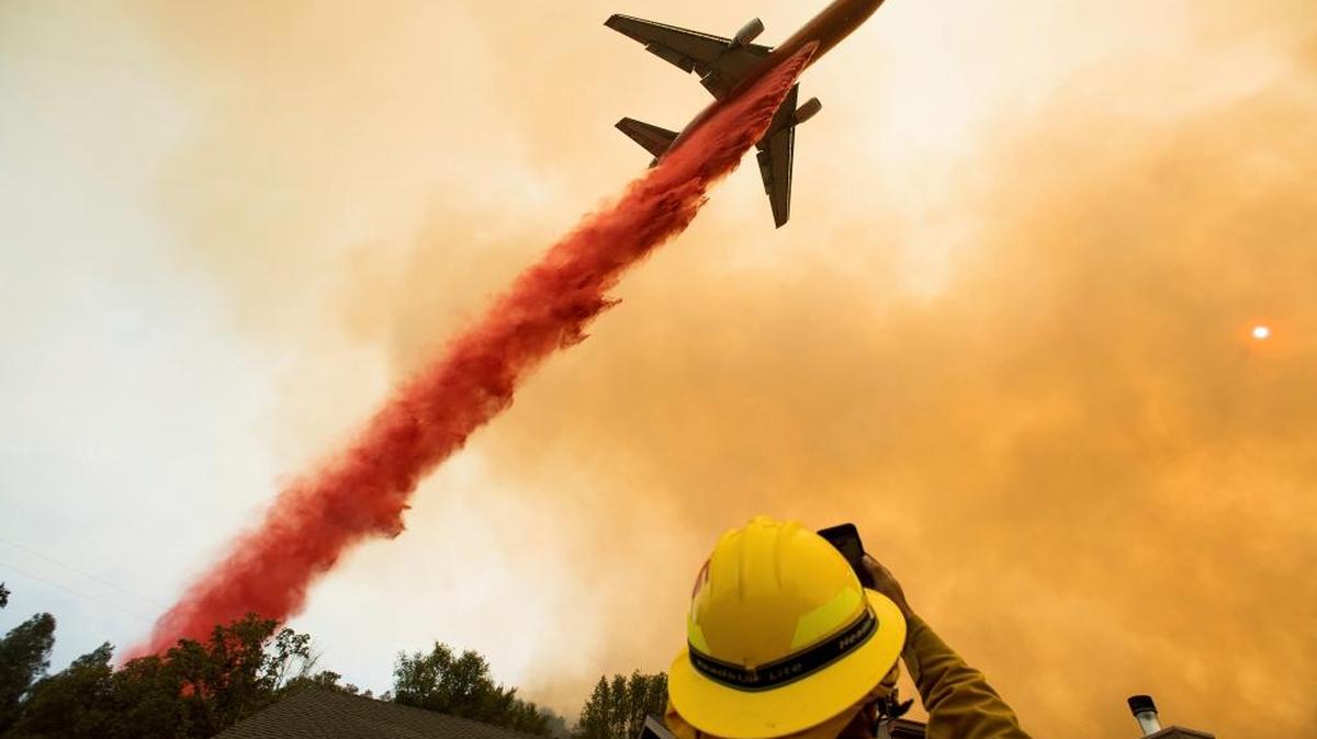 An air tanker drops fire retardant while battling a wildfire near Mariposa Wednesday. The blaze has forced thousands of people from homes in and around a half-dozen small communities, and many can use mental health assistance in this crisis, letter writer Carla Lalonde says.