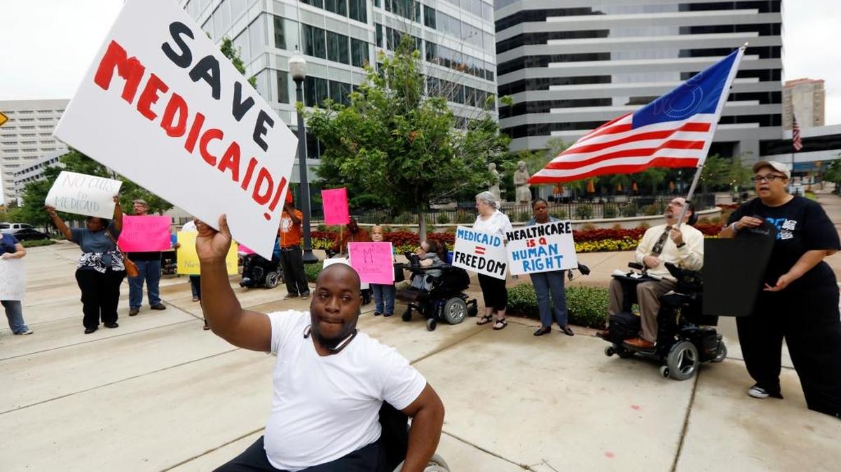 Mario Henderson leads chants of ‘save Medicaid’ as Medicaid recipients and their supporters stage a protest outside the building that houses the offices of U.S. Sen. Thad Cochran, R-Miss., Thursday, June 29, 2017, in Jackson, Miss.