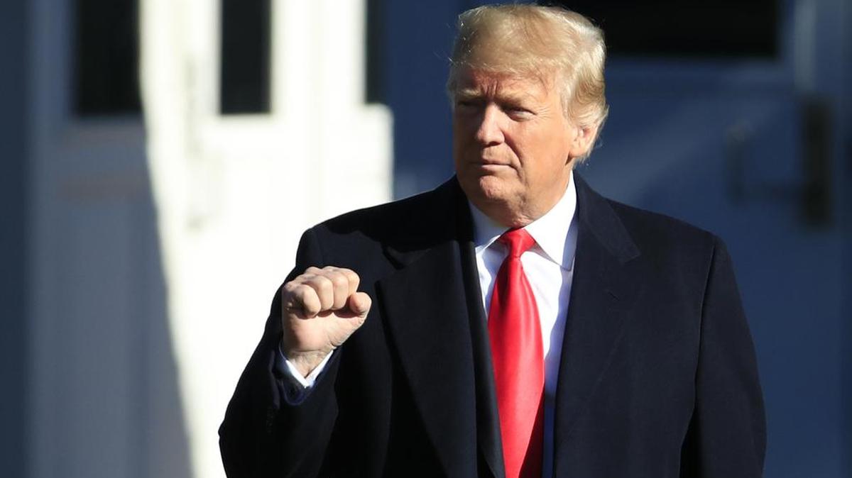 President Donald Trump gestures as he leaves the White House in Washington, Thursday, Oct. 18, 2018.