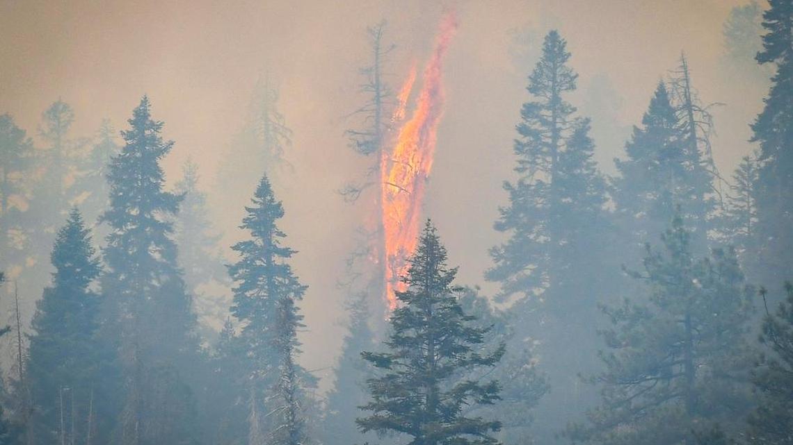 Flames erupt on a hillside above China Peak ski area near Highway 168 as the Creek Fire raged through the area last month.
