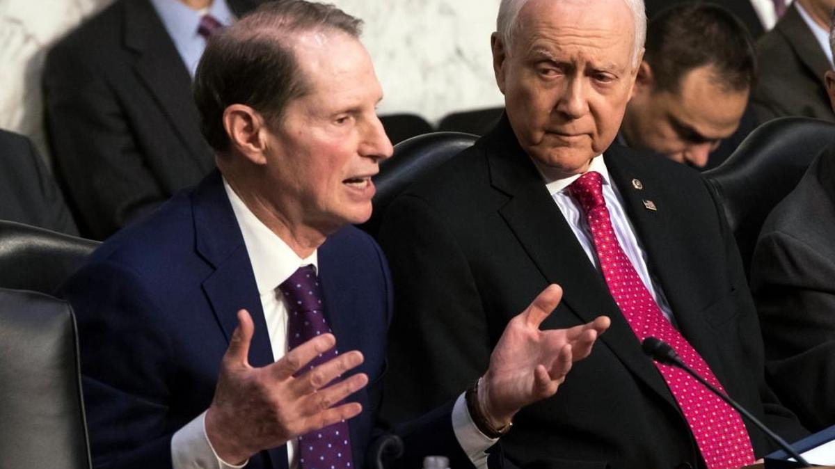 Sen. Ron Wyden, D-Ore., left, the top Democrat on the Senate Finance Committee, criticizes the Republican tax reform plan while Chairman Orrin Hatch, R-Utah, listens to his opening statement as the panel begins work overhauling the nation's tax code, on Capitol Hill in Washington, Monday. The legislation in the House and Senate carries high political stakes for President Donald Trump and Republican leaders in Congress, who view passage of tax cuts as critical to the GOP’s success at the polls next year.