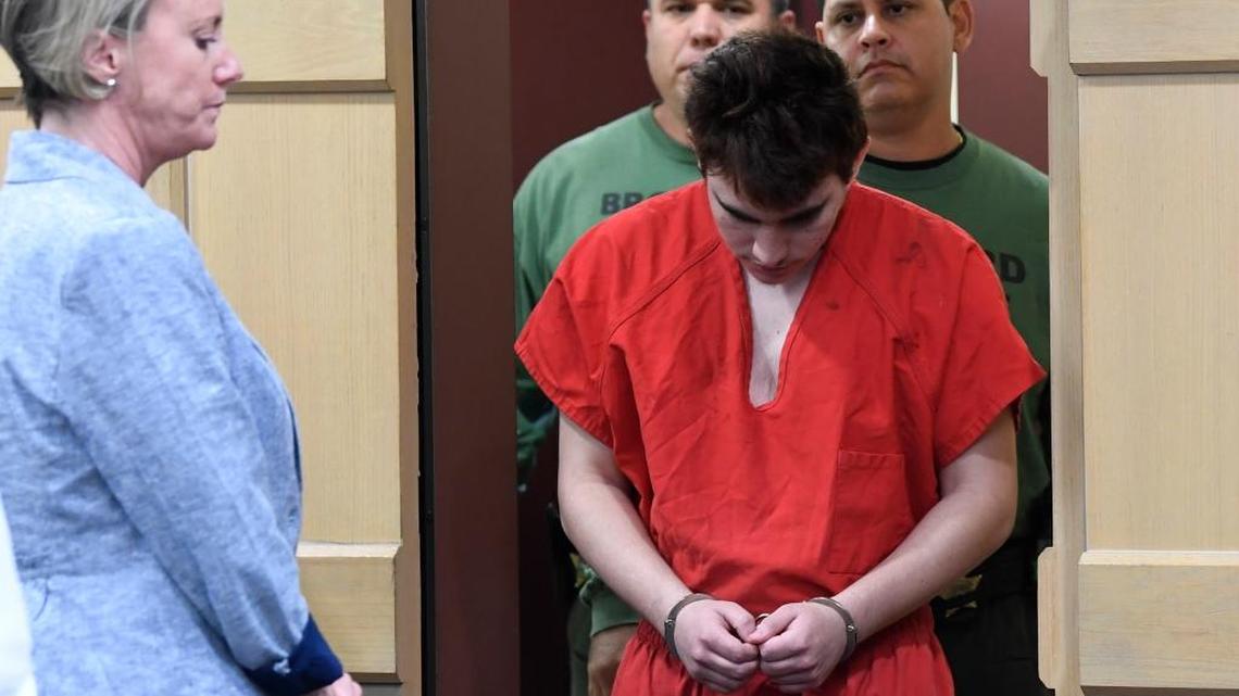 Florida school shooting suspect Nikolas Cruz walks into a courtroom for a hearing as his attorney Assistant Public Defender Melisa McNeill, left, waits in Fort Lauderdale, Fla., Friday, April 27, 2018. The hearing is expected to deal with several procedural issues possibly including setting an initial trial date. Cruz is charged with 17 counts of murder and 17 counts of attempted murder in the Feb.14, 2018 school shooting at Marjory Stoneman Douglas High School in Parkland, Fla. (Taimy Alvarez/South Florida Sun-Sentinel via AP, Pool)