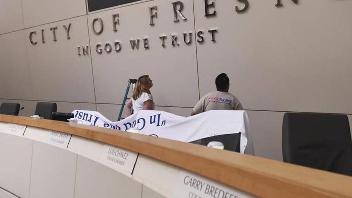 Newly installed lettering ‘In God We Trust’ is shown in the Fresno City Council chambers June 13, 2017. An official unveiling was held June 15. ERIC PAUL ZAMORA