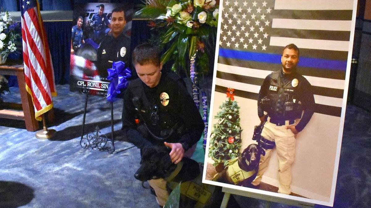 Newman Police Cpl. Ashley Williams is pictured with Sam, Ronil Singh’s K-9 at the West Side Theatre in downtown Newman, Calif. on Jan. 4, 2019. A viewing was held in Newman for Singh, the police corporal who was killed during a traffic stop on Dec. 26.