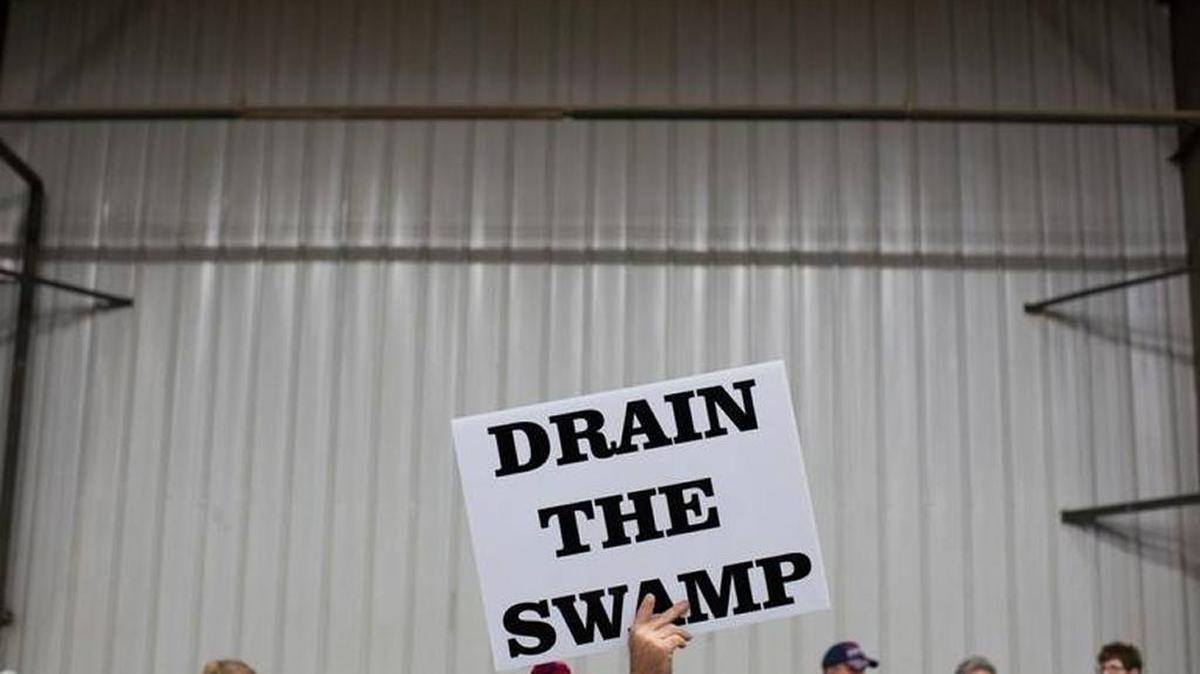 In this Oct. 27, 2016, photo, supporters of then-Republican presidential candidate Donald Trump hold signs during a campaign rally in Springfield, Ohio.
