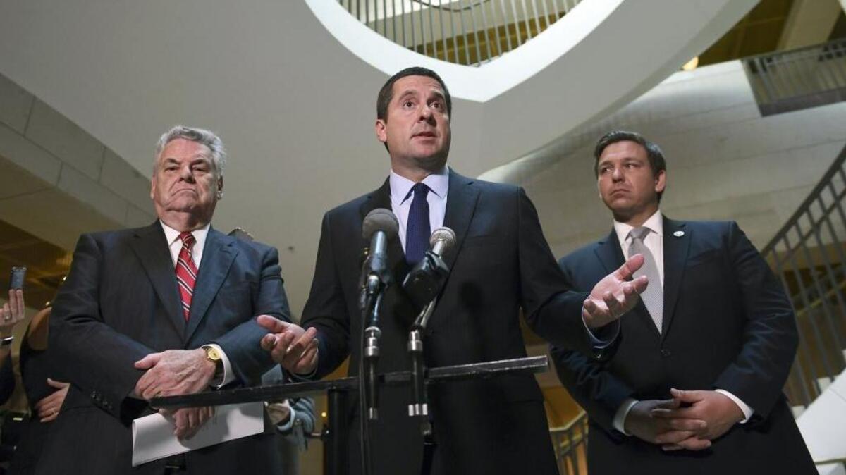 House Intelligence Committee Chairman Rep. Devin Nunes, R-Calif., center, standing with Rep. Peter King, R-N.Y., left, and Rep. Ron DeSantis, R-Fla., right, speaks on Capitol Hill in Washington.