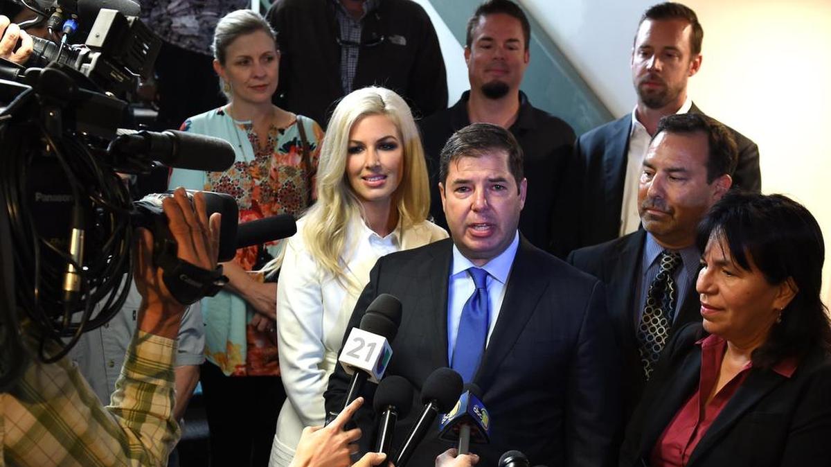 Assemblyman Joaquin Arambula, surrounded by family, including his wife, Elizabeth, in white, and attorneys Michael Aed and Margarita Martinez-Baly at right, makes a statement to the media after being found not guilty in his misdemeanor child abuse trial.