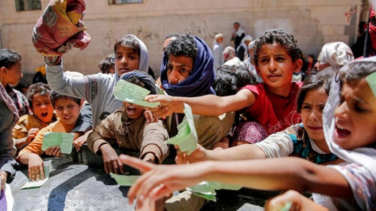 In this April, 13 file photo, Yemenis present documents in order to receive food rations provided by a local charity, in Sanaa, Yemen. Speaking to The Associated Press by telephone from Sanaa, the head of the World Food Program, Stephen Anderson, warned Nov. 20 that millions of Yemenis are at risk and will face more deaths as the humanitarian situation deteriorates and deliveries remain blocked from getting to those most needy.
