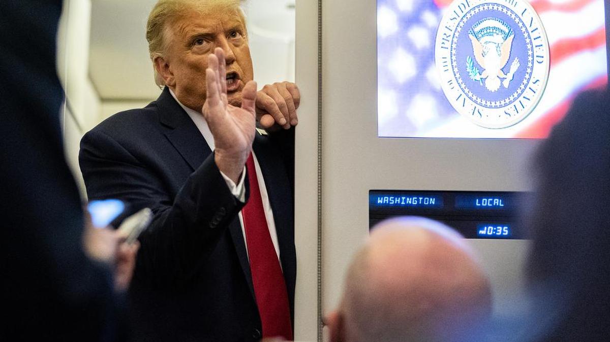 President Donald Trump speaks with reporters aboard Air Force One as he returns to Washington from Nashville, Tenn., following the final presidential debate, late Thursday, Oct. 22, 2020.