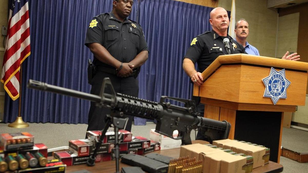 Fresno Police chief Jerry Dyer, center, gives a news conference with deputy police chief Keith Foster, left, and Lt. David Newton in front of a large cache of weapons, money and marijuana seized in a bust in 2012.