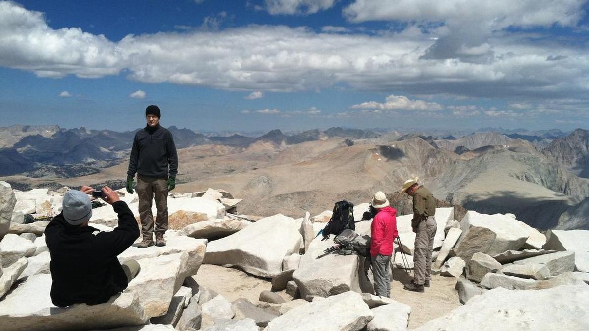 The Fresno Bee hikers pose for photographs and admire views on a July morning from the summit of Mount Whitney, the highest point in the lower 48 states.