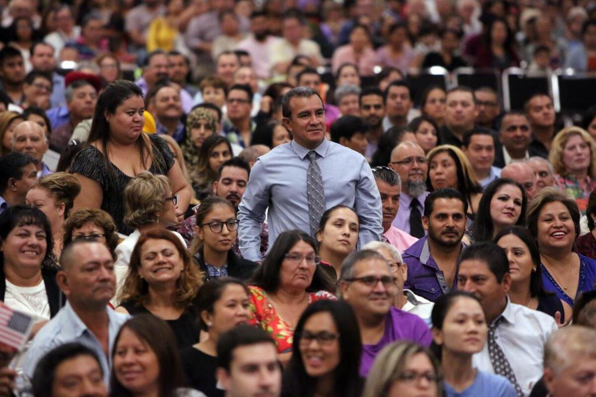 Six hundred eighty people became U.S. citizens during the monthly naturalization ceremony at the Fresno Convention Center in August 2016. Nestor Amaya of El Salvador stands up during the ceremony. He lives in Bakersfield.