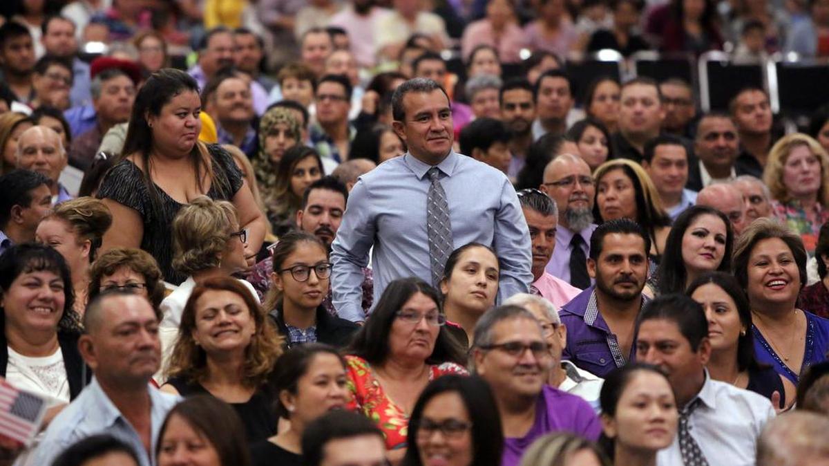 Six hundred eighty people became U.S. citizens during the monthly naturalization ceremony at the Fresno Convention Center in August 2016. Nestor Amaya of El Salvador stands up during the ceremony. He lives in Bakersfield.