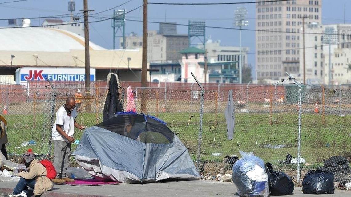 A homeless man sets up his tent near downtown Fresno. Both Fresno County and the city of Fresno introduced ordinances in late July and early August 2024 banning camping on streets, sidewalks parks and other public property. Both the city and county laws include misdemeanor penalties such as fines or jail time for those who refuse to move when asked by police officers or sheriff’s deputies.