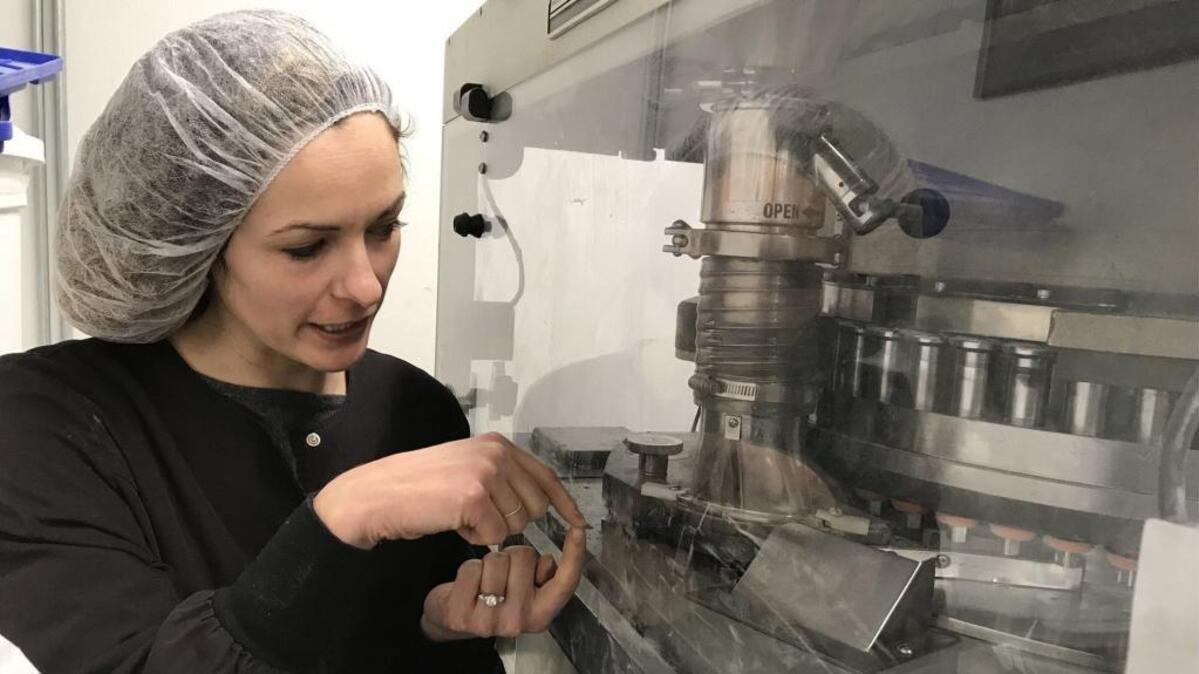 At an industrial facility in West Oakland, Kristi Knoblich, who founded Kiva Confections with her husband, Scott Palmer, shows how their micro-dose Petra mints are made in an industrial press. The mints. with 2.5 milligrams of THC, may soon become Kiva's most popular product.