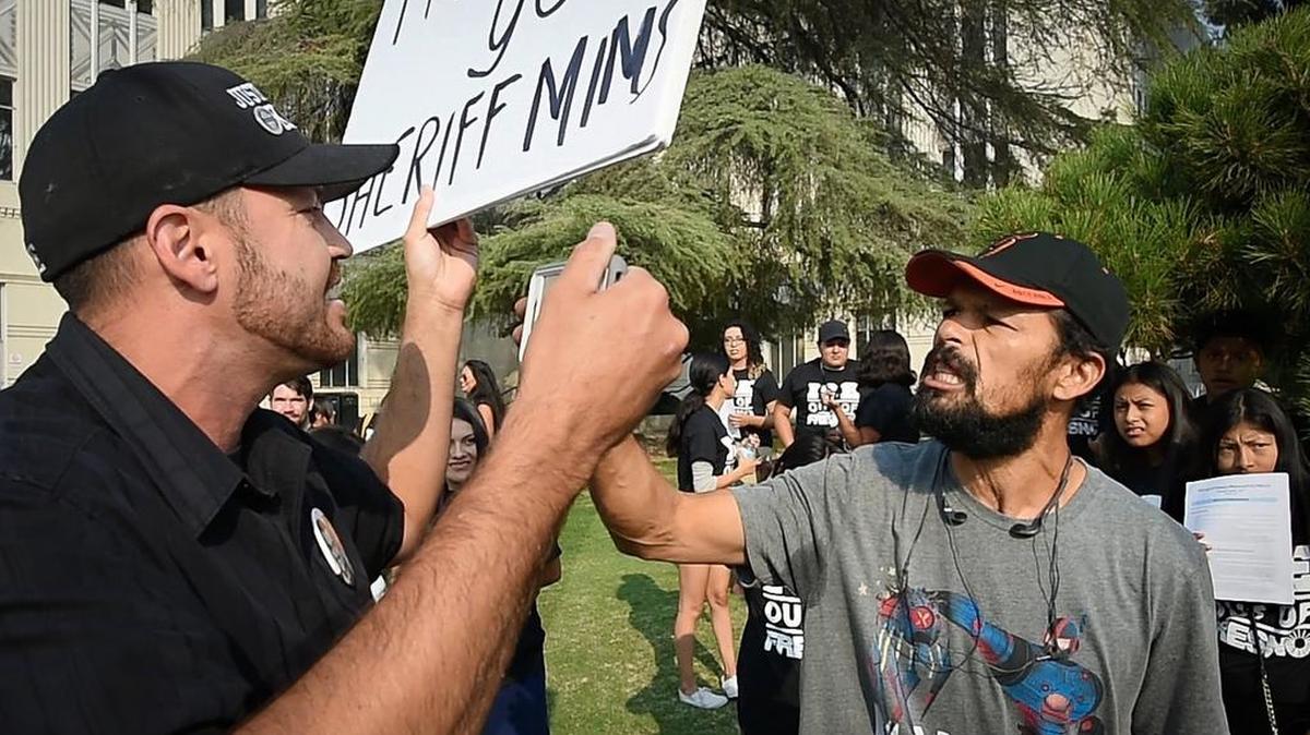 Pro-ICE supporter Ben Bergquam, left, and Jaimie Loza, right, who spoke out for immigrant rights, have a heated exchange at the community rally outside the Hall of Records building, Tuesday Aug 8, 2018. The demonstration was held to protest recent arrests by ICE agents at the Fresno County Courthouse.