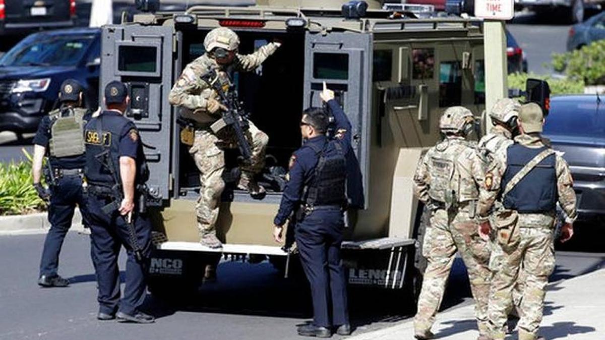 Armed law enforcement personnel exit an armored vehicle outside YouTube headquarters, Tuesday in San Bruno. A woman opened fire at YouTube headquarters setting off a panic among employees and wounding several people before fatally shooting herself, police and witnesses said.