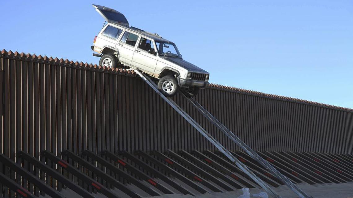 In this file photo provided by the U.S. Customs and Border Protection, a silver Jeep Cherokee that suspected smugglers were attempting to drive over the U.S.-Mexico border fence is stuck at the top of a makeshift ramp early Wednesday, Oct. 31, 2012, near Yuma, Ariz. U.S. Border Patrol agents from the Yuma Station seized both the ramps and the vehicle, which stalled at the top of the ramp after it became high centered. The fence is approximately 14 feet high where the would-be smugglers attempted to illegally drive across the border. The two suspects fled into Mexico when the agents arrived at the scene. President Donald Trump is threatening to declare a national emergency to circumvent Congress if he can't reach a deal with Democrats to fund his promised border wall.