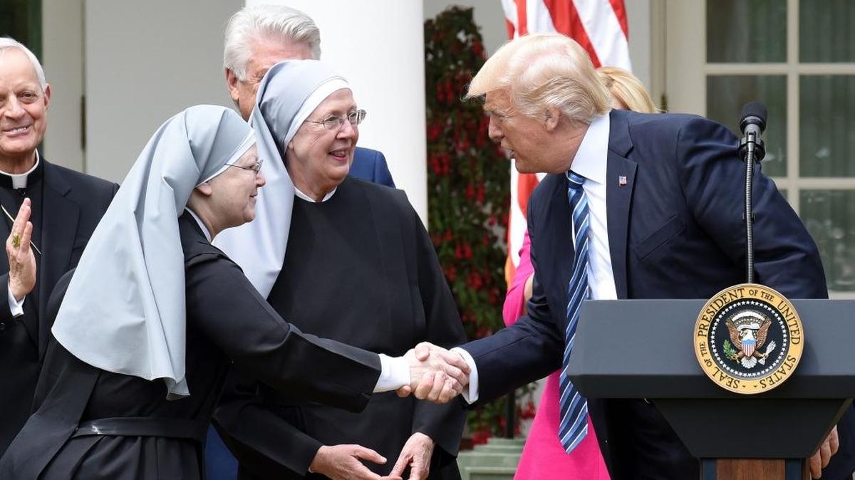 President Donald Trump greets the Little Sisters of the Poor before signing an executive order on religious liberty during a National Day of Prayer Event.