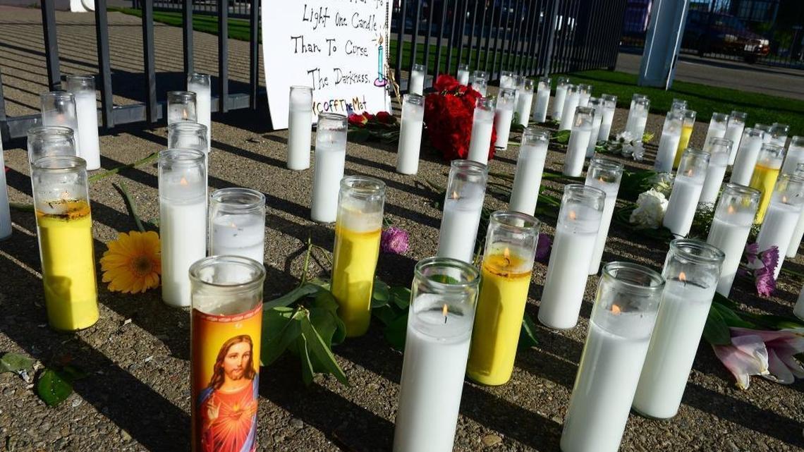 A memorial of candles and flowers blossomed at the scene of an April 2017 triple-homicide near the Catholic Charities offices near downtown Fresno, California. Three white men were killed in what investigators described as a hate crime.