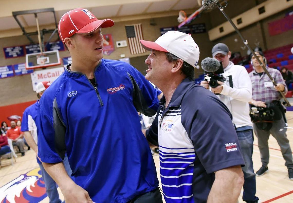 Former Firebaugh High star quarterback Josh Allen hugs and chats with former coach Bill Magnusson before a rally Thursday afternoon, April 18, 2018 in the Firebaugh gym.