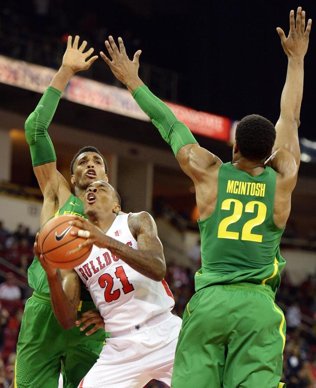 Fresno State’s Deshon Taylor, center, can’t find an opening while defended by Oregon’s MiKyle McIntosh, right, and Kenny Wooten during the Ducks’ 68-61 victory at the Save Mart Center in Fresno on Saturday, Dec. 16, 2017.