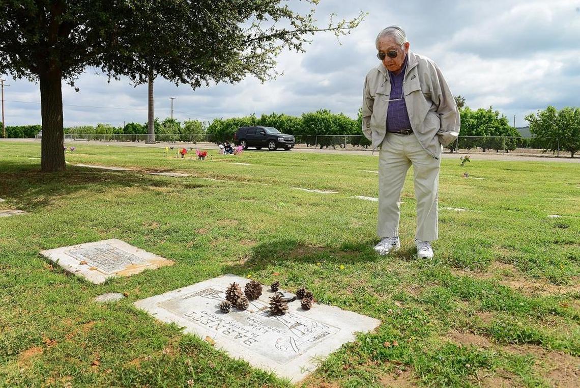 Fresno State baseball/football legend Fibber Hirayama stops in front the grave marker of old friend and former Exeter High teammate Lyle Barnett at an Exeter cemetery on Tuesday, April 25, 2017.