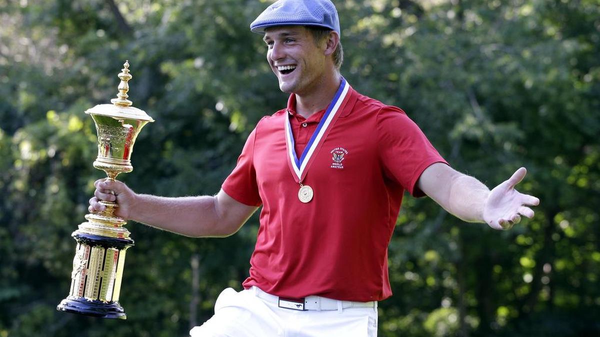 
Clovis native Bryson DeChambeau holds out the Havemeyer Cup and looks for someone to hug after winning the 115th U.S. Amateur Championship on Sunday in Olympia Fields, Ill.
